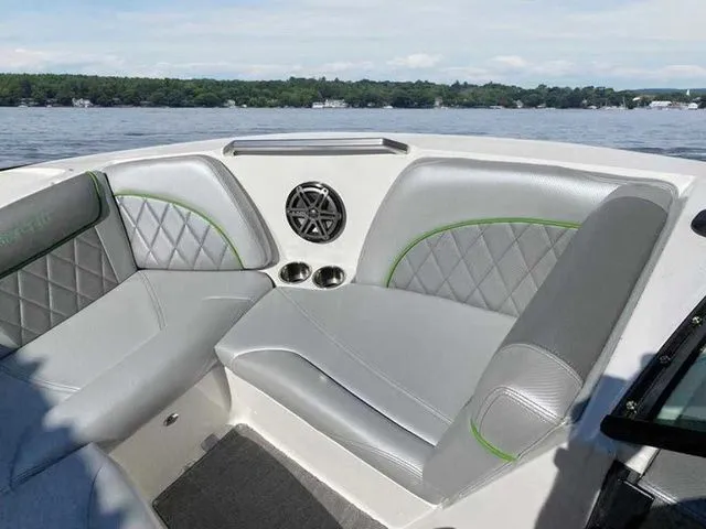 Slide: The Image of 2014 MasterCraft X30 boat interior with gray seating and speaker on a lake. - 31