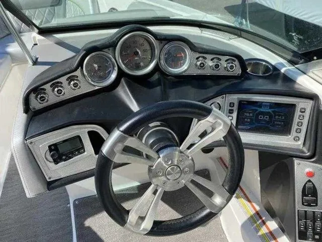 Slide: The Image of 2014 MasterCraft X30 boat dashboard with steering wheel, gauges, and control panel. - 32