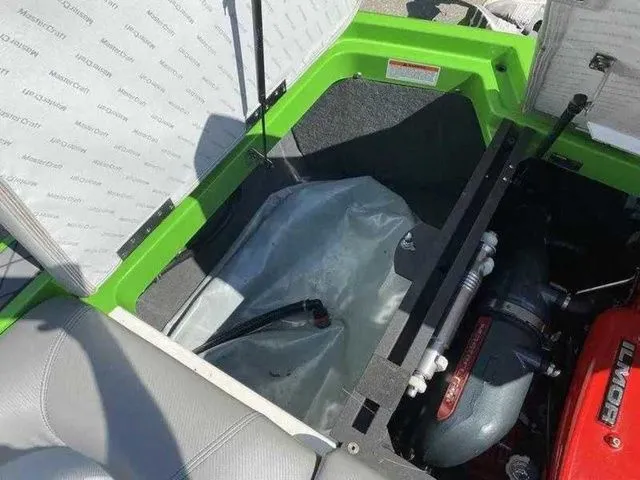 Slide: The Image of 2014 MasterCraft X30 engine compartment with green accents and visible components. - 35