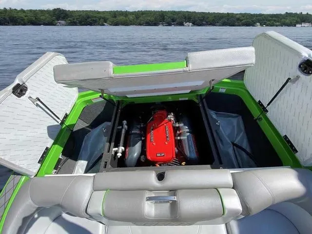 Slide: The Image of 2014 MasterCraft X30 boat engine compartment with open hatches, showcasing a vibrant red engine. - 9