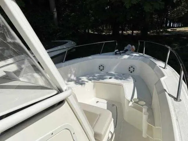 Slide: The Image of 2024 Boston Whaler 230 Outrage boat interior with seating and railings. - 10