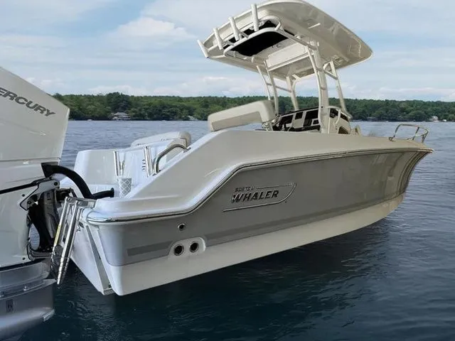 Slide: The Image of 2024 Boston Whaler 230 Outrage boat on water, featuring sleek design and powerful Mercury engine. - 11