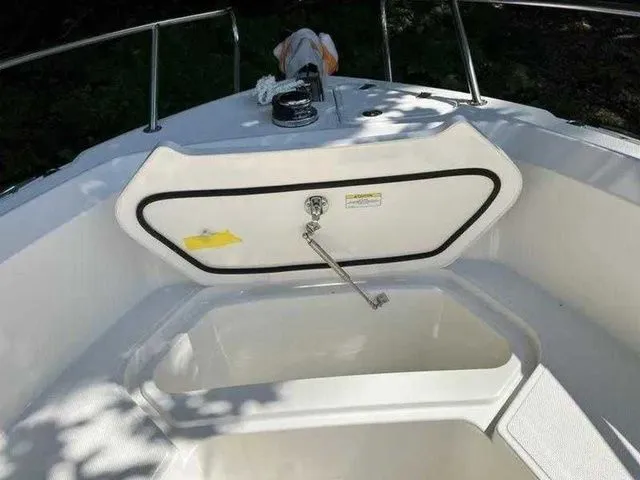 Slide: The Image of 2024 Boston Whaler 230 Outrage boat interior, featuring storage compartment and sleek design. - 14
