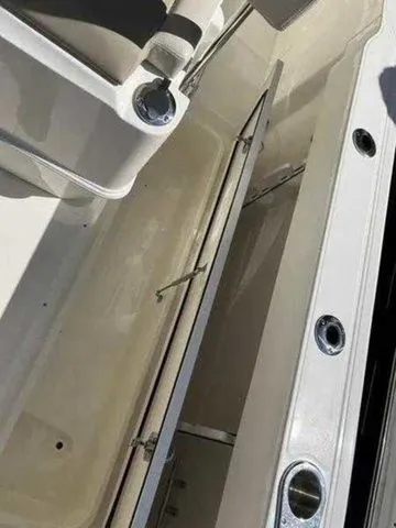 Slide: The Image of 2024 Boston Whaler 230 Outrage boat interior detail with storage compartment. - 16