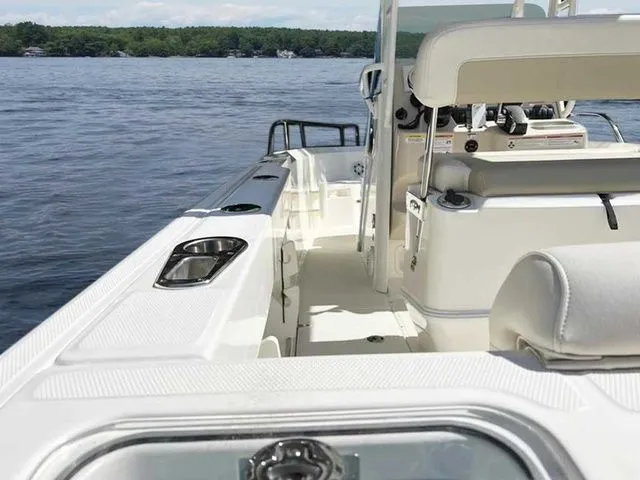 Slide: The Image of 2024 Boston Whaler 230 Outrage boat interior on a calm lake. - 18