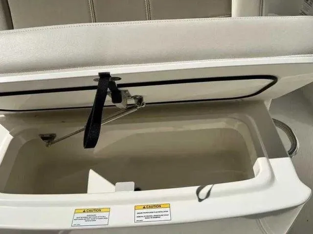 Slide: The Image of Open storage compartment on 2024 Boston Whaler 230 Outrage boat. - 19