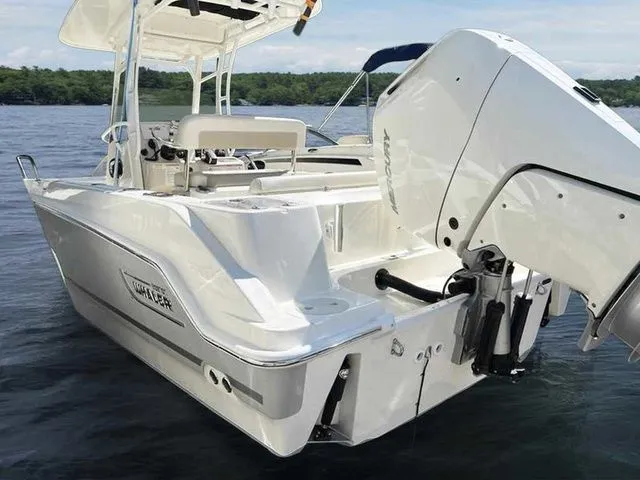 Slide: The Image of 2024 Boston Whaler 230 Outrage boat on water, showcasing sleek design and powerful engine. - 3