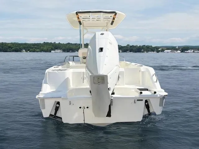 Slide: The Image of 2024 Boston Whaler 230 Outrage boat on calm water, rear view. - 4