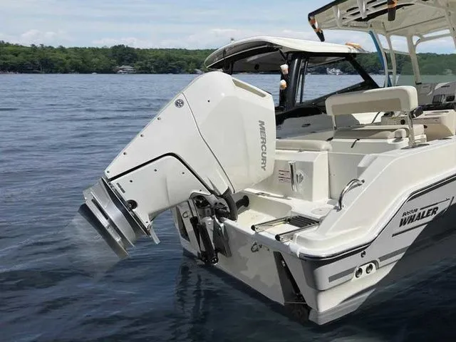 Slide: The Image of 2024 Boston Whaler 230 Outrage boat with Mercury engine on a lake. - 8