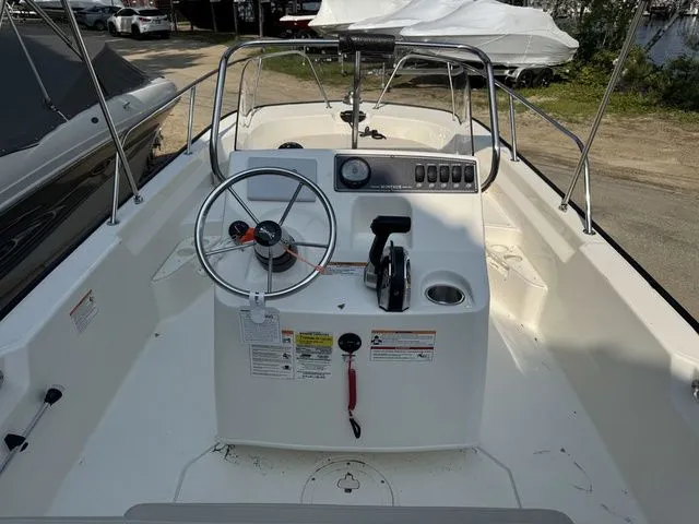 Slide: The Image of 2025 Boston Whaler 170 Montauk boat cockpit with steering wheel and control panel. - 10