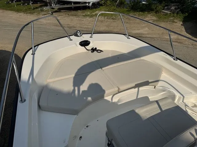 Slide: The Image of 2025 Boston Whaler 170 Montauk boat interior with cushioned seating and railings. - 14