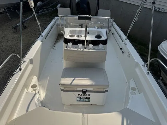 Slide: The Image of 2025 Boston Whaler 170 Montauk boat interior with Igloo cooler and steering console. - 16