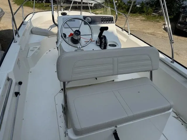 Slide: The Image of 2025 Boston Whaler 170 Montauk boat interior with steering console and seating. - 9