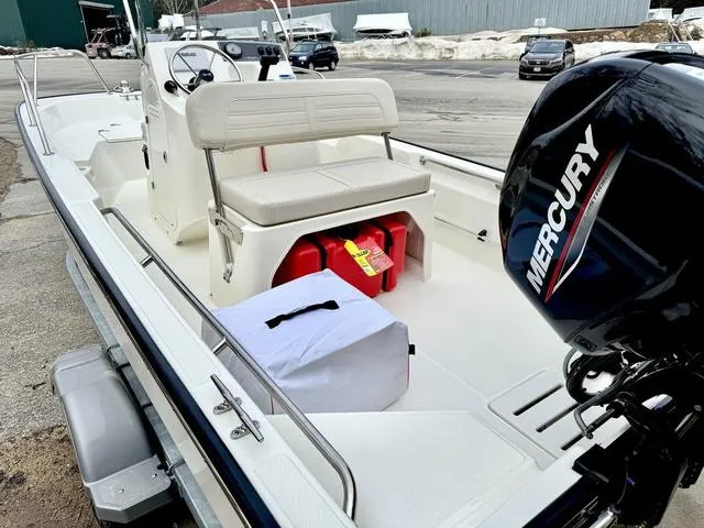Slide: The Image of 2025 Boston Whaler 150 Montauk boat with Mercury engine, docked and ready for use. - 10