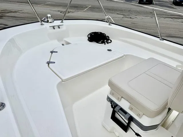 Slide: The Image of 2025 Boston Whaler 150 Montauk boat interior with seating and storage compartment. - 14