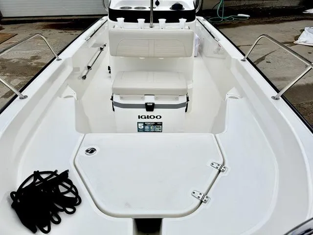 Slide: The Image of 2025 Boston Whaler 150 Montauk boat interior with Igloo cooler and seating. - 15
