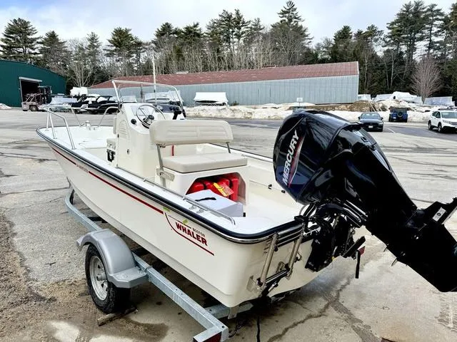Slide: The Image of 2025 Boston Whaler 150 Montauk boat on trailer with Mercury outboard motor. - 4