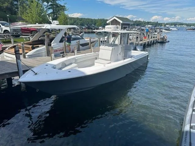 Slide: The Image of 2019 Contender 32ST boat docked at a marina on a sunny day. - 1