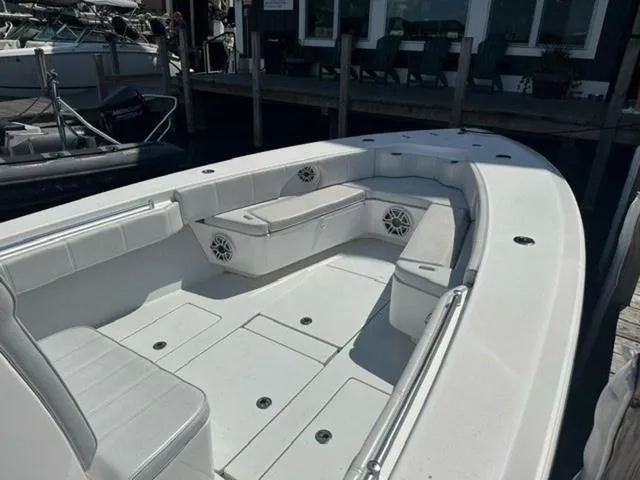 Slide: The Image of 2019 Contender 32ST boat with spacious seating and sleek design at a dock. - 10