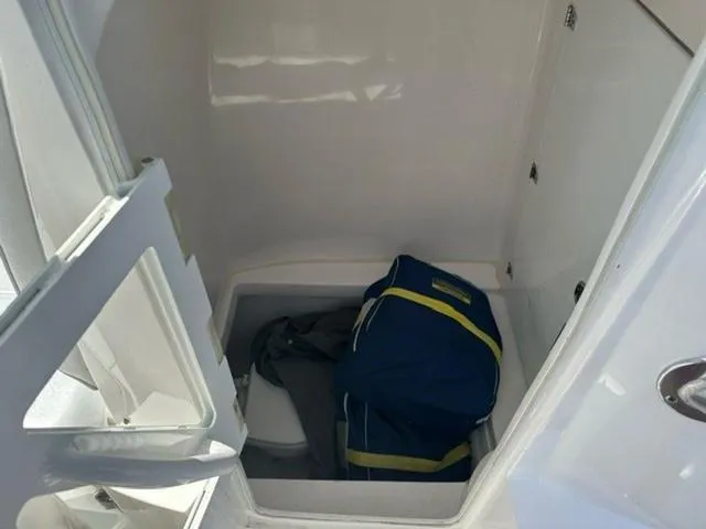 Slide: The Image of Storage compartment in 2019 Contender 32ST boat with a blue bag inside. - 11