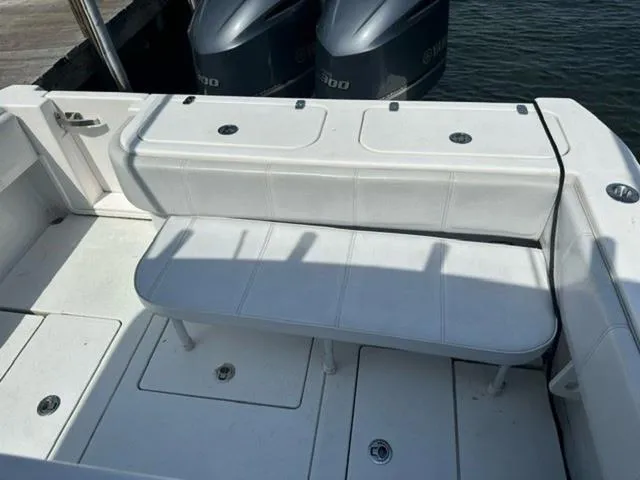 Slide: The Image of 2019 Contender 32ST boat with white seating and dual outboard engines. - 14