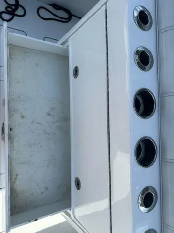 Slide: The Image of 2019 Contender 32ST boat storage compartment with rod holders. - 16