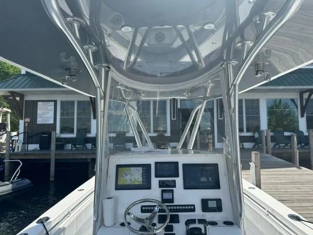 Slide: The Image of 2019 Contender 32ST boat console with navigation equipment, docked near waterfront buildings. - 17