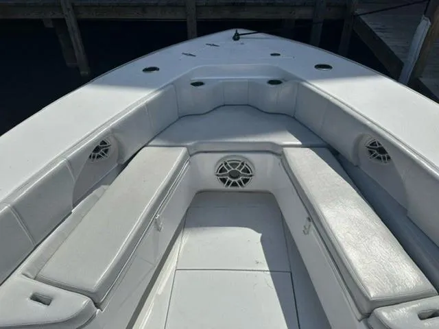 Slide: The Image of 2019 Contender 32ST boat interior with cushioned seating and built-in speakers. - 18