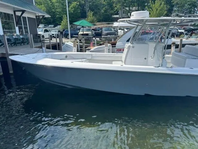 Slide: The Image of 2019 Contender 32ST boat docked at marina, clear water, sunny day. - 2