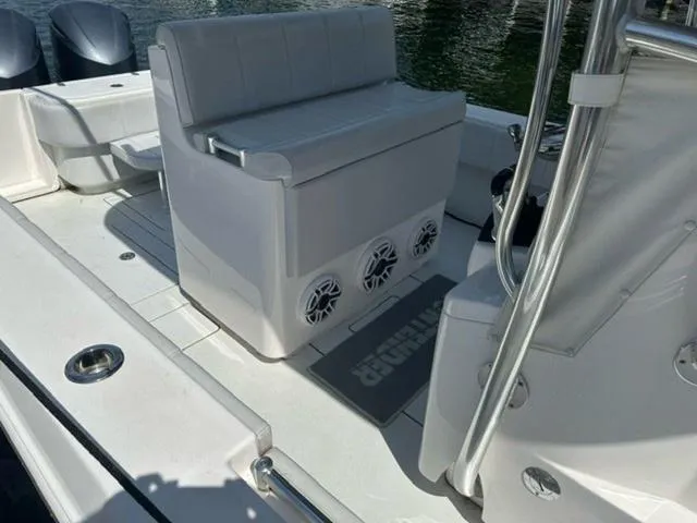 Slide: The Image of 2019 Contender 32ST boat interior with seating and speakers, docked on water. - 4