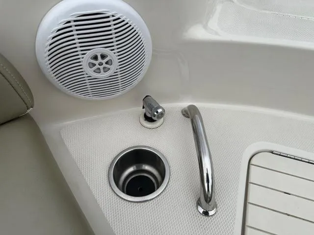 Slide: The Image of 2005 Sea Ray 240 Sundeck interior with speaker, cup holder, and handle. - 10