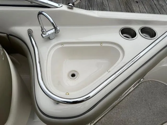 Slide: The Image of 2005 Sea Ray 240 Sundeck sink and cup holders on deck. - 15