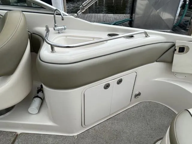 Slide: The Image of 2005 Sea Ray 240 Sundeck interior with sink and storage area. - 16
