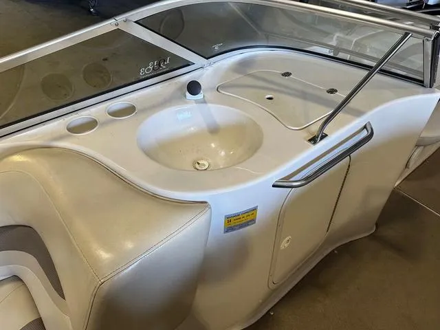 Slide: The Image of 2003 Larson 234 ESCAPE boat interior with sink and seating area. - 10