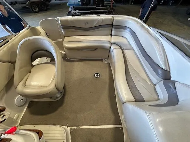 Slide: The Image of 2003 Larson 234 ESCAPE boat interior with beige seating and carpeted floor. - 11