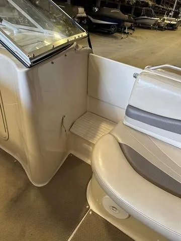 Slide: The Image of 2003 Larson 234 ESCAPE boat interior with beige seating and carpeted flooring. - 13