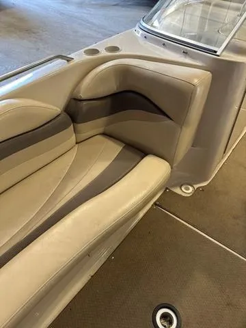 Slide: The Image of 2003 Larson 234 ESCAPE boat interior with beige seating and cup holders. - 14