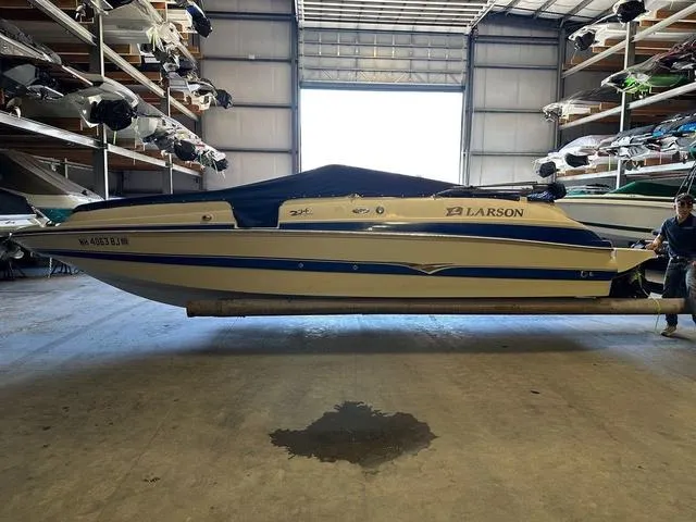 Slide: The Image of 2003 Larson 234 ESCAPE boat in storage facility, side view. - 4