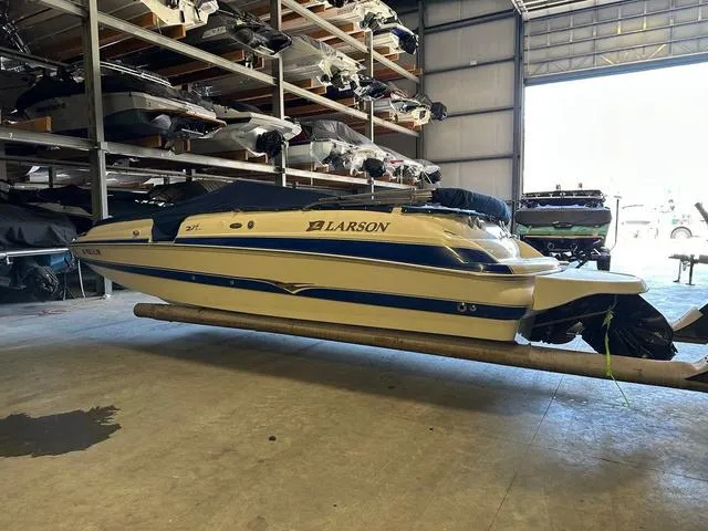 Slide: The Image of 2003 Larson 234 ESCAPE boat in storage, covered and elevated indoors. - 5