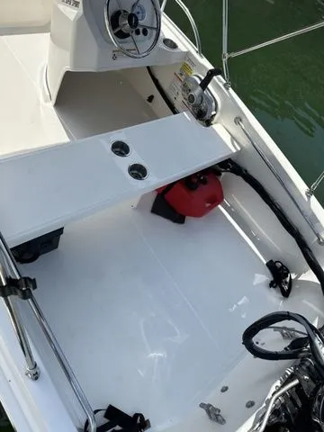 Slide: The Image of 2024 Boston Whaler 130 Super Sport boat interior with steering wheel and seating area. - 4