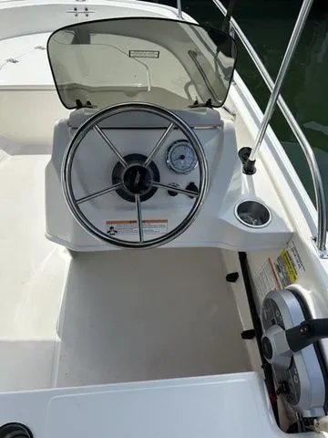 Slide: The Image of 2024 Boston Whaler 130 Super Sport steering console with windshield and controls. - 5