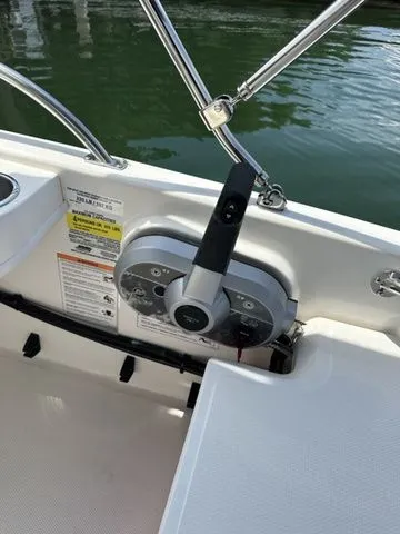Slide: The Image of 2024 Boston Whaler 130 Super Sport boat dashboard with steering wheel and controls. - 6