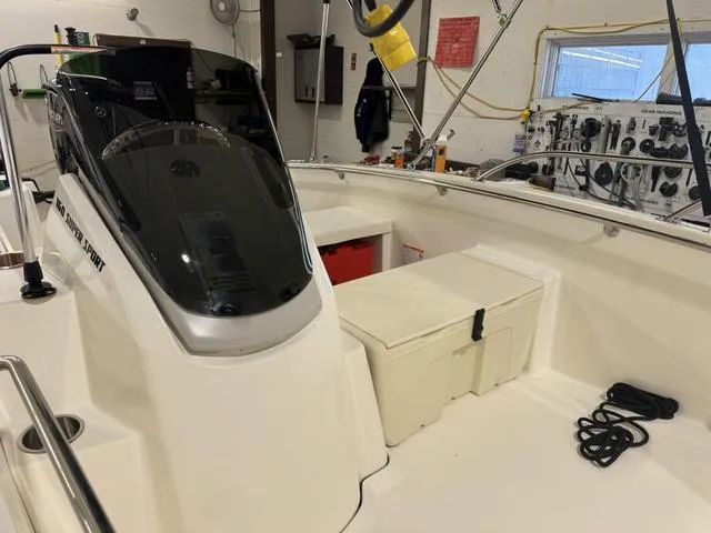 Slide: The Image of 2025 Boston Whaler 160 Super Sport interior with console and seating in a workshop setting. - 10
