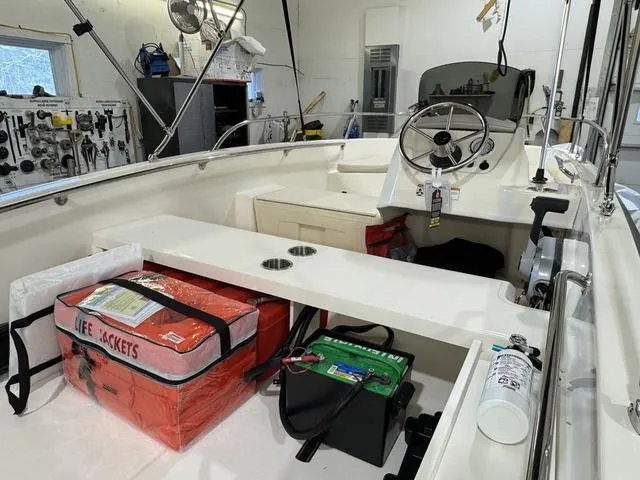 Slide: The Image of 2025 Boston Whaler 160 Super Sport interior with life jackets and safety equipment. - 3