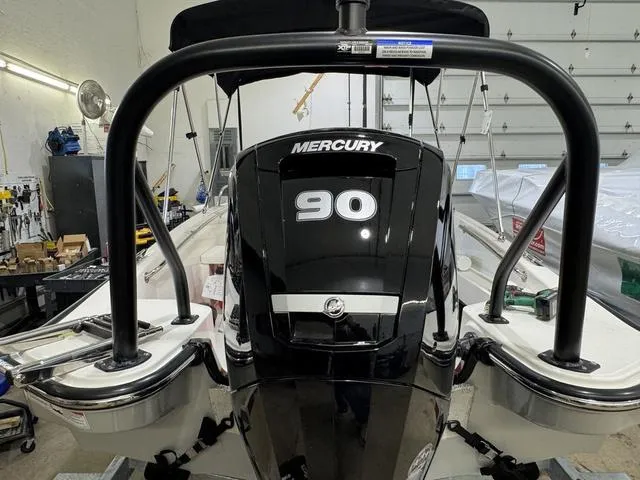 Slide: The Image of 2025 Boston Whaler 160 Super Sport with Mercury 90 engine in a garage. - 4