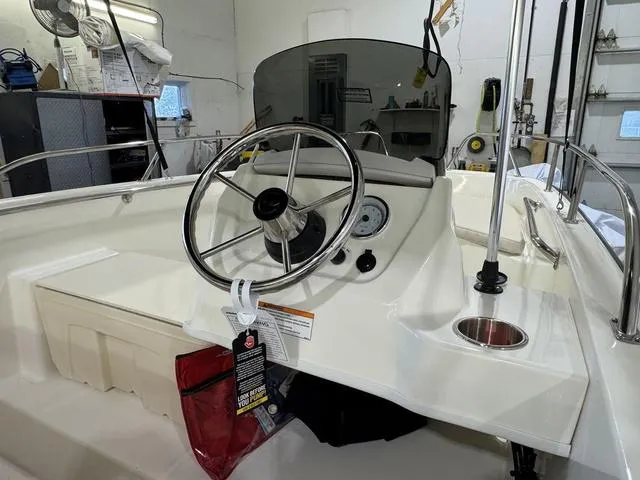 Slide: The Image of 2025 Boston Whaler 160 Super Sport boat interior with steering wheel and dashboard controls. - 5