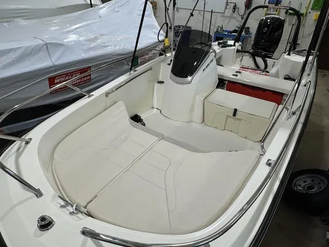 Slide: The Image of 2025 Boston Whaler 160 Super Sport boat interior, featuring seating and storage compartments. - 8