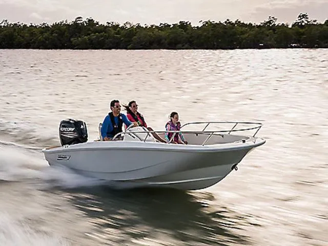 Slide: The Image of 2025 Boston Whaler 160 Super Sport boat cruising with three passengers on a sunny day. - 1
