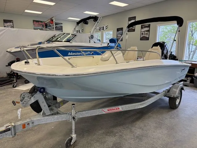 Slide: The Image of 2025 Boston Whaler 160 Super Sport boat on trailer in showroom. - 1