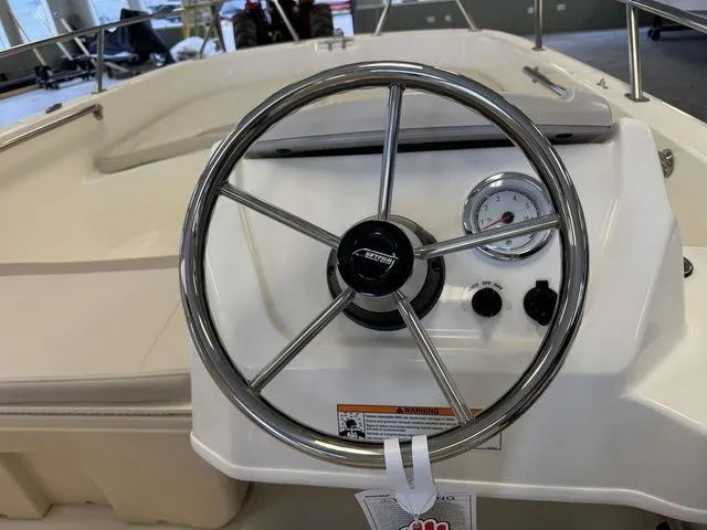Slide: The Image of 2025 Boston Whaler 160 Super Sport steering wheel and dashboard close-up. - 12